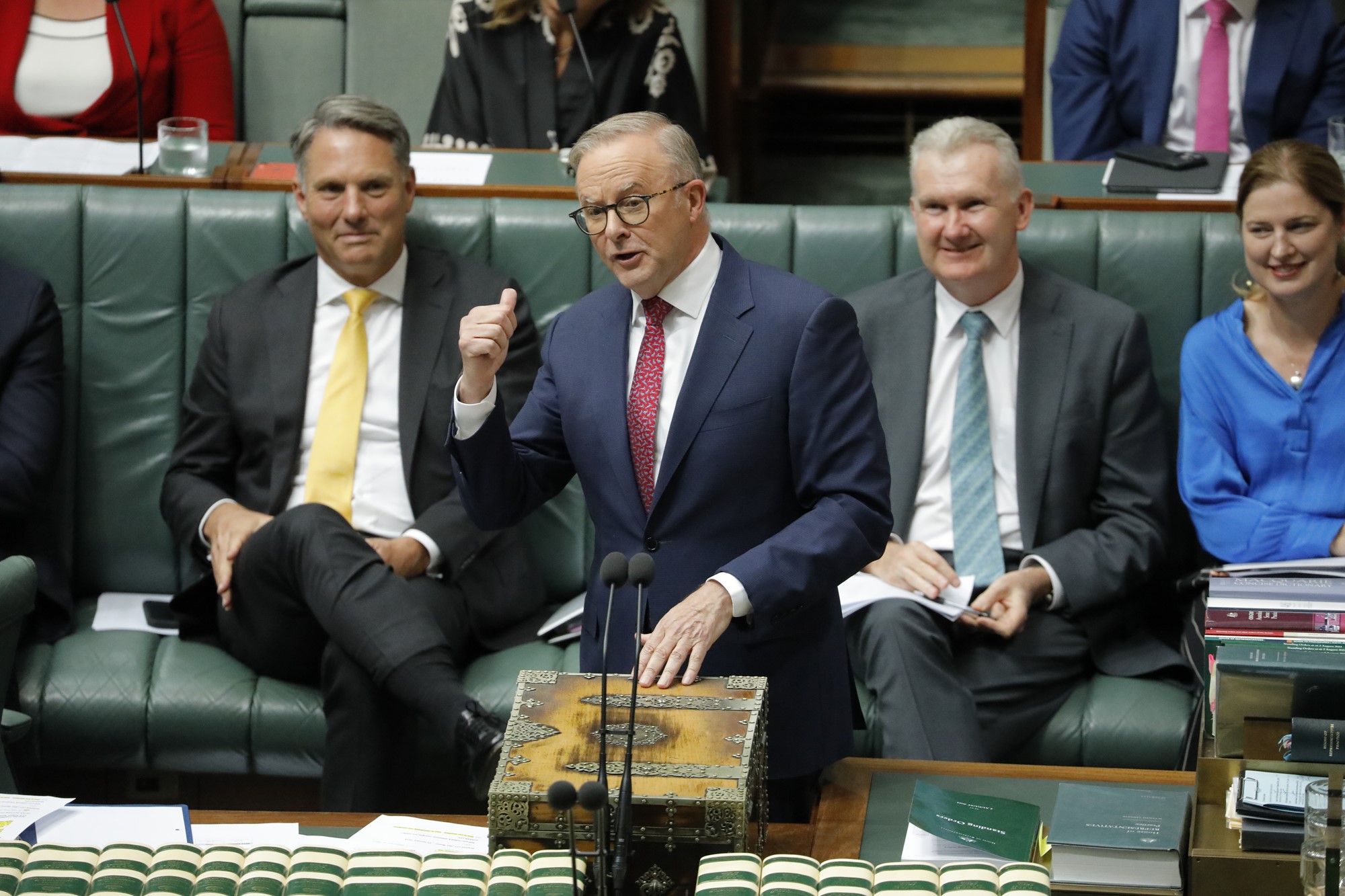 anthony albanese gestures while speaking in parliament house as front benchers laugh behind him 
